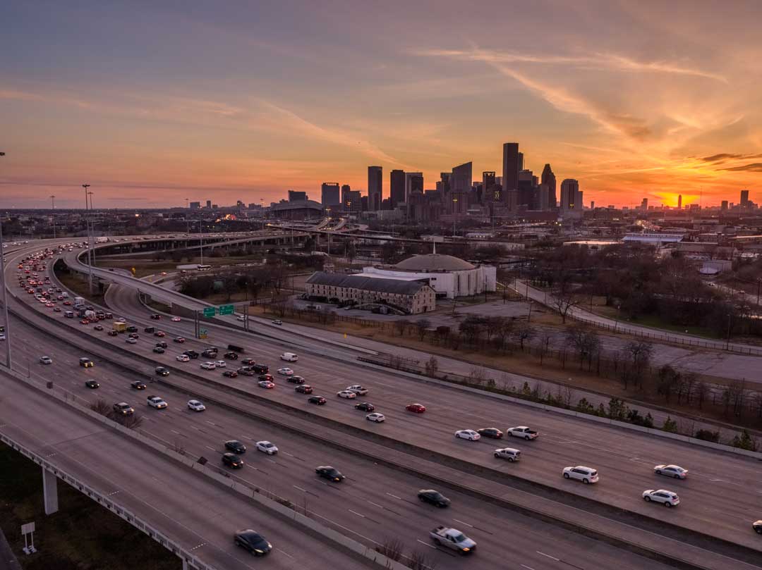 Downtown Houston with I-59 in the foreground. It is sunset.