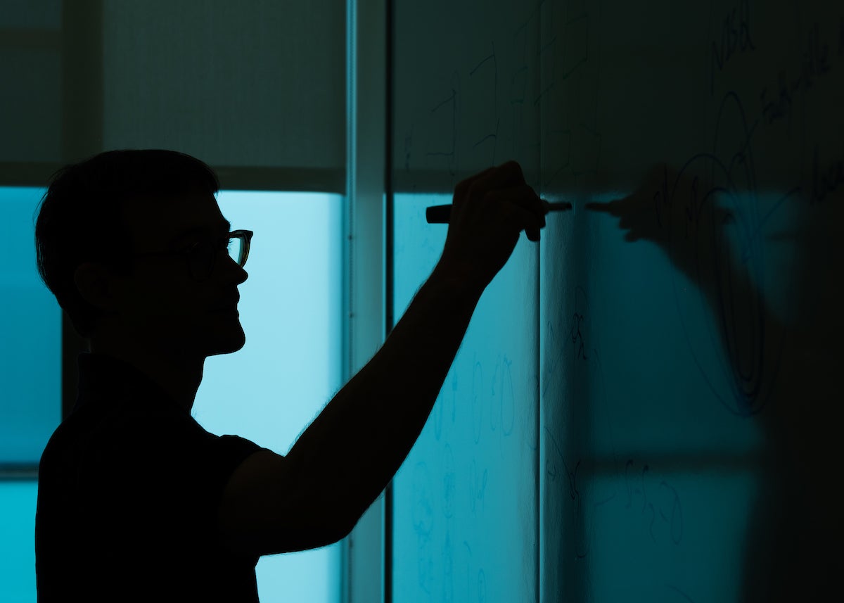Picture of student writing on a board
