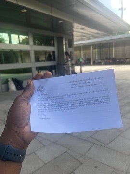 Osinachi Okafor holding the almighty “White Paper” confirming her visa renewal approval at the American Embassy in Santo Domingo. June, 2025.