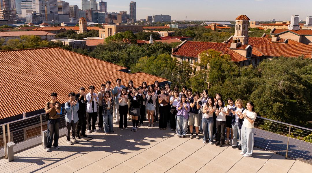 South Korean undegraduates pose for a photo with the Rice campus in the background
