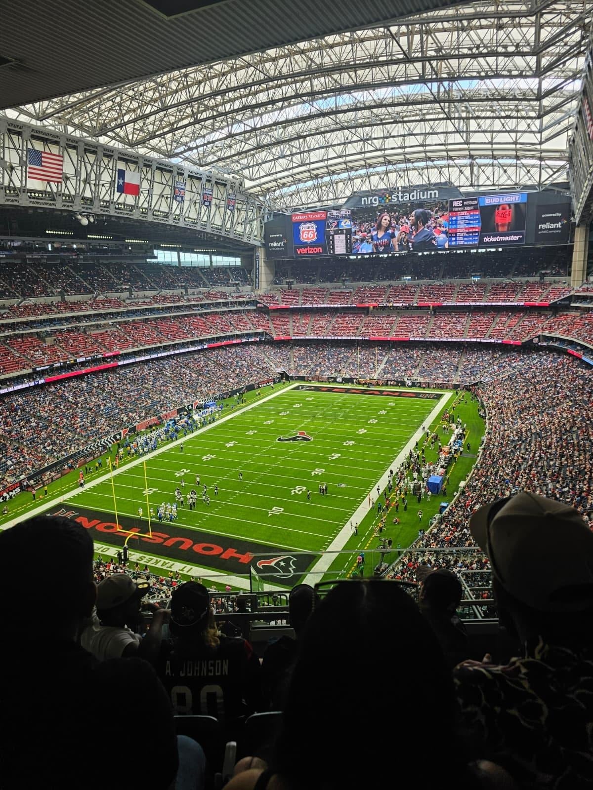 a green soccer field seen from the bleachers. 