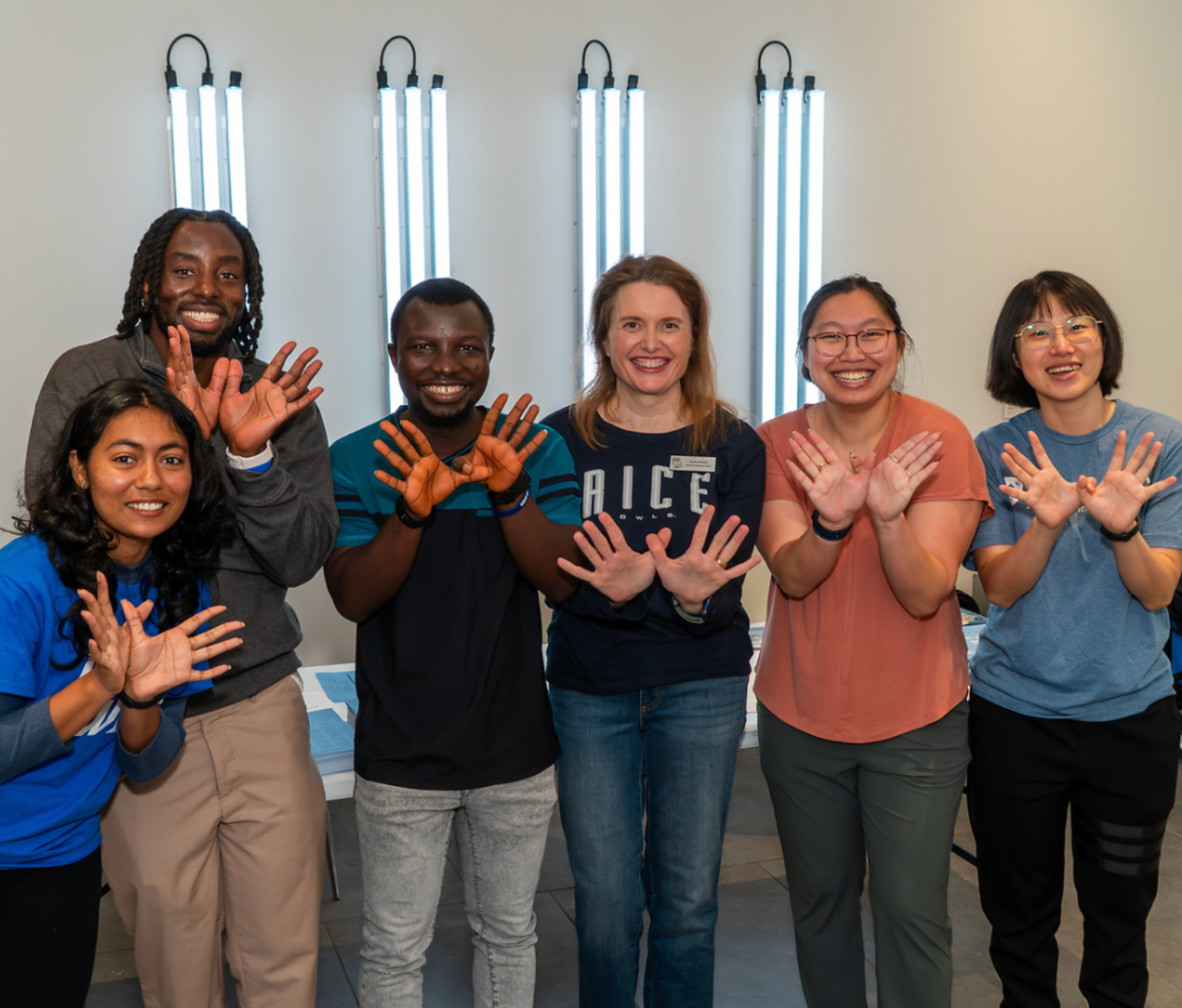 Rice graduate students with rice owls pose 