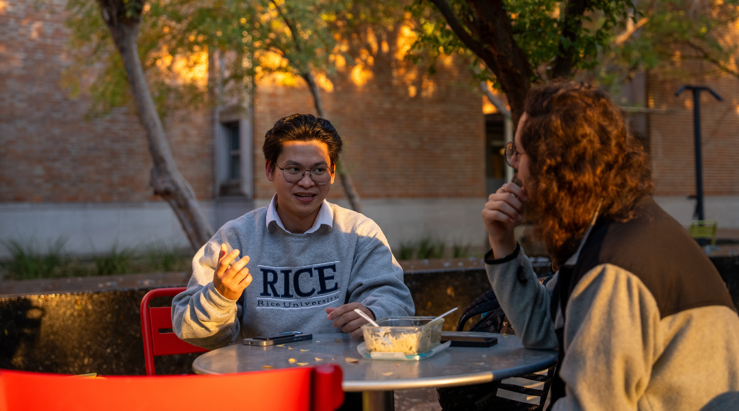 Nathaniel Uy visits with a fellow graduate ambassador