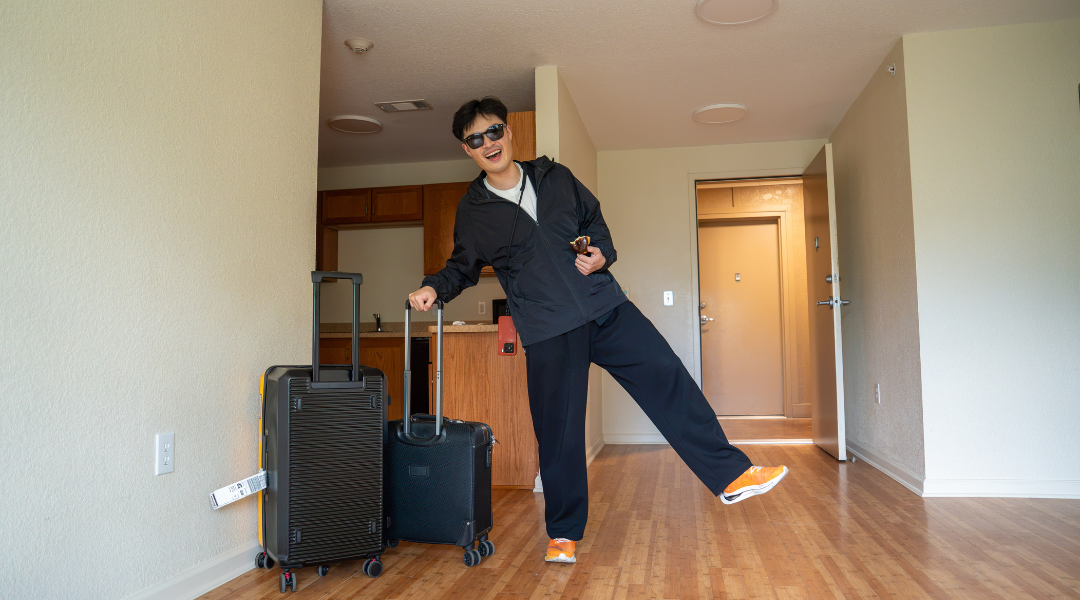 Ziao Li poses in his new apartment