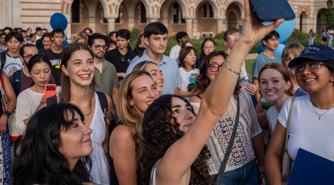 Grad students pose for a selfie in the Sallyport procession