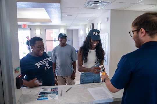 Ph.D. student Cara Baah-Binney from Cincinnati is checked in by a graduate resident assistant