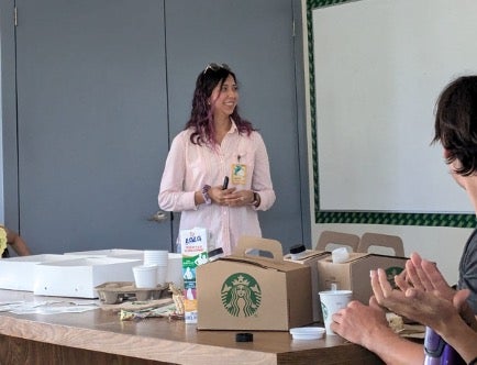 Astrid in the front of a classroom.
