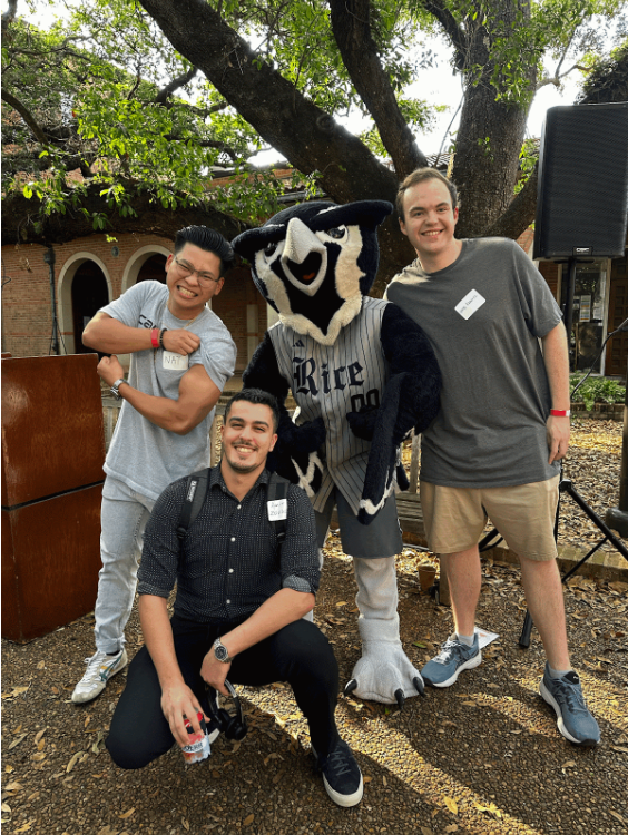 A photo of Nathaniel and two friends with Rice's Mascot, Sammy the Owl.