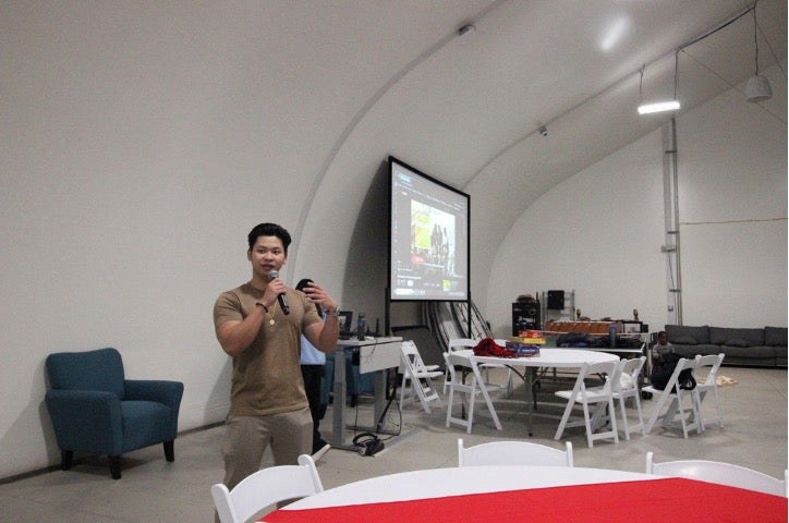 Grad Student Nathaniel using a microphone
