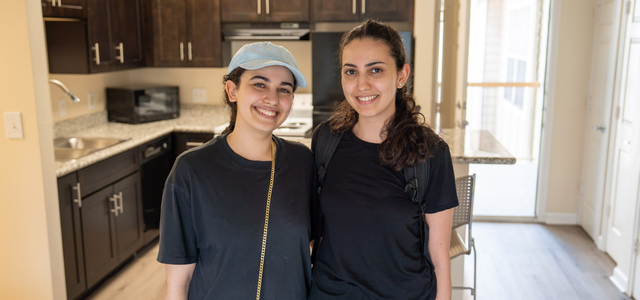 Malak Soubai (left) with her sister in her new apartment