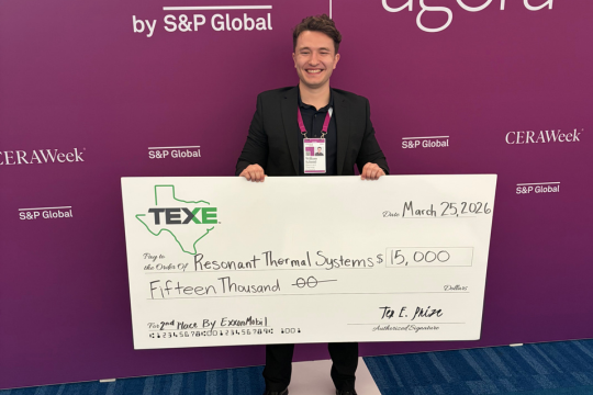Postdoc Will Schmid with TEX-E award check