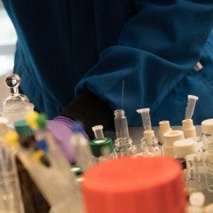 Student in lab working with purple gloves