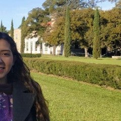 Astrid Campos in front of Fondren Library on the Rice campus