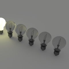 Row of lightbulbs, all the same - except one is lit!