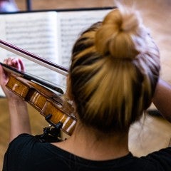 Student playing the violin. 