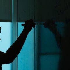 Picture of student writing on a board