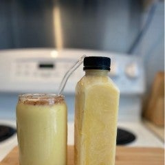 A cup and a bottle of mango Lassi.  2025