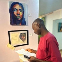 An Art enthusiast looking at Osinachi Okafor's Exhibit (XX Exhibition) at Awka Museum Foundation. 