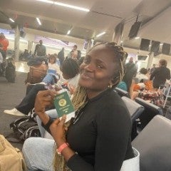 Osinachi Okafor, holding her passport booklet at the Atlanta Airport. August 2023.