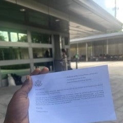Osinachi Okafor holding the almighty “White Paper” confirming her visa renewal approval at the American Embassy in Santo Domingo. June, 2025.