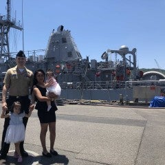 Geovanny Montemayor and family in front of a Naval ship