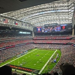 a green soccer field seen from the bleachers. 