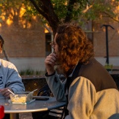 Nathaniel Uy visits with a fellow graduate ambassador