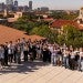 South Korean undegraduates pose for a photo with the Rice campus in the background