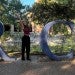 Olivia Beddow on campus at the Rice sign in front of the Welcome Center