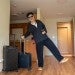 Ziao Li poses in his new apartment